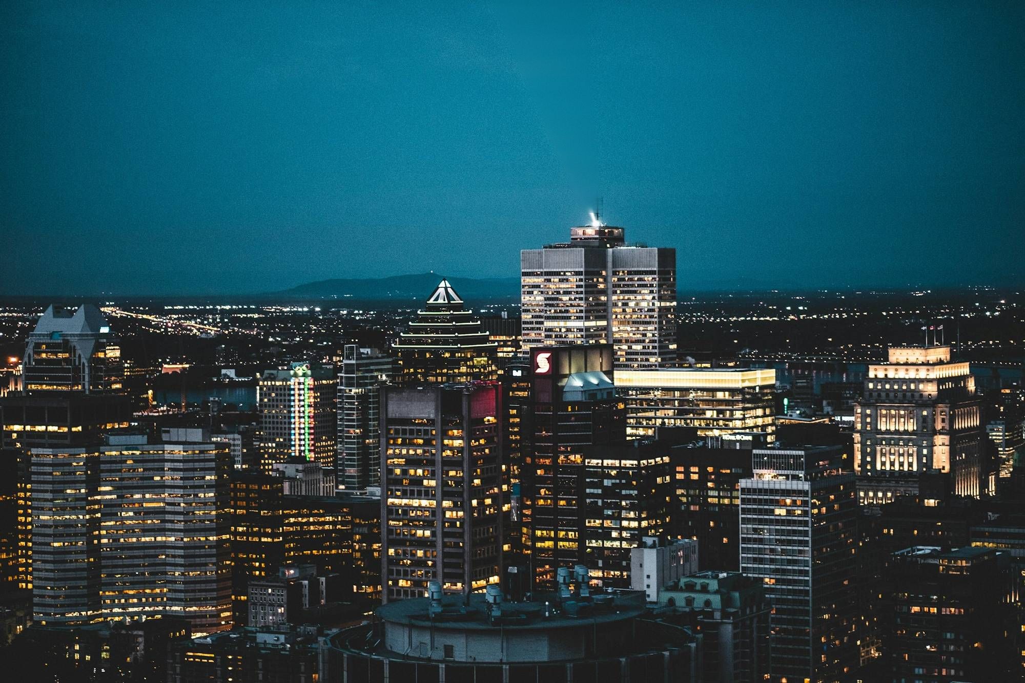 Downtown Montreal at night, the Place Ville Marie beacon sweeping the sky
